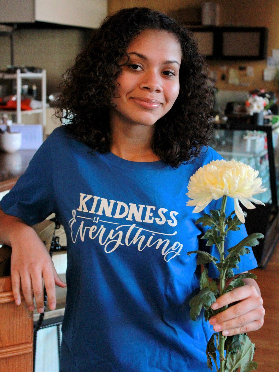 Bright blue t- shirt that says "kindness is everything " in a trendy font. Fair Anita