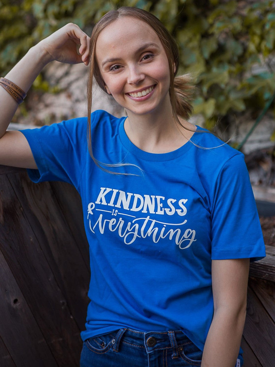 Bright blue t- shirt that says "kindness is everything " in a trendy font. Fair Anita