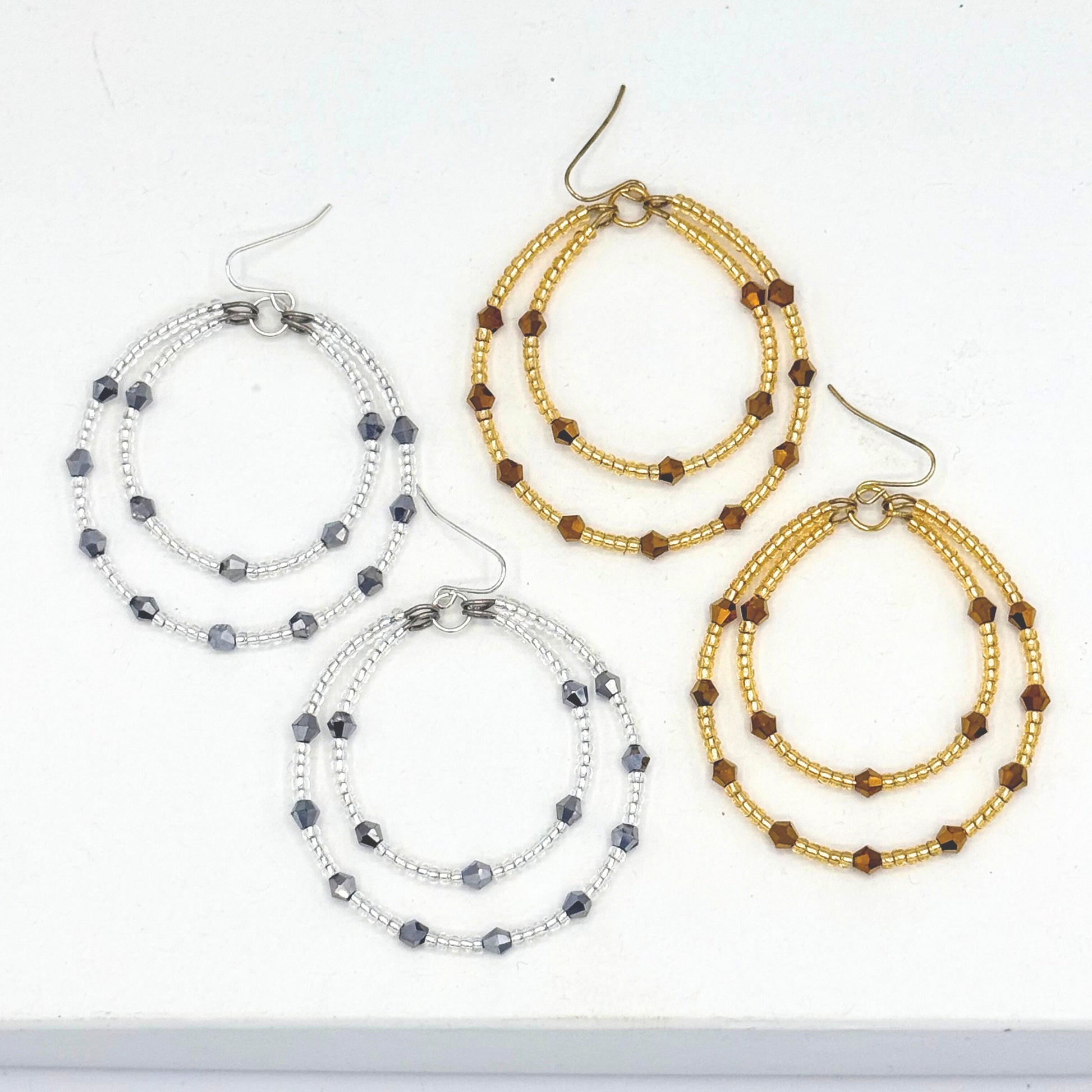 Set of beaded hoop earrings on a white background