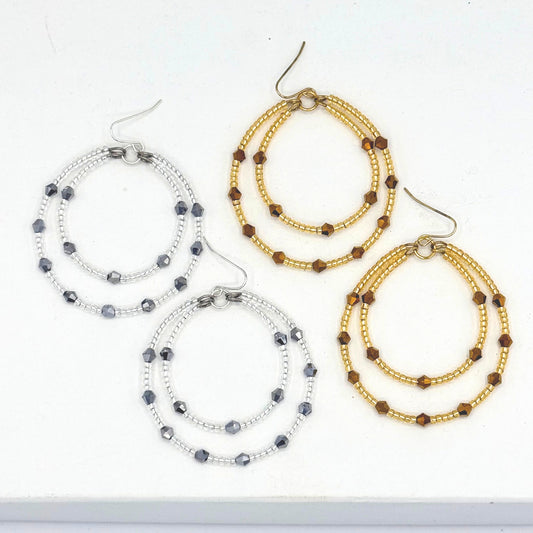 Set of beaded hoop earrings on a white background